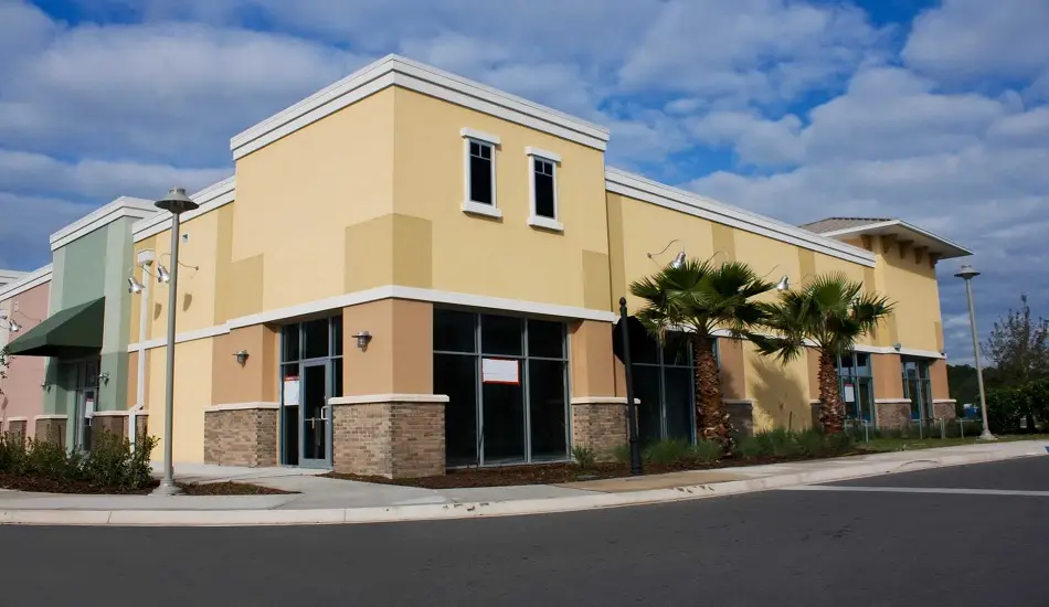 Office exterior with warm yellow and tan paint color by an exterior painter in Lake County, IL