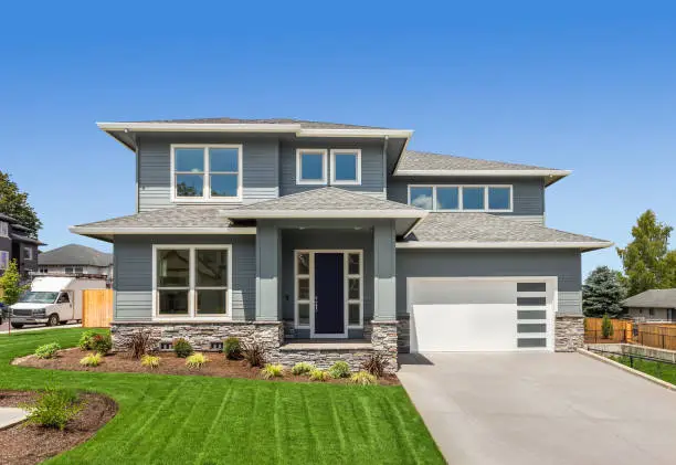 Modern gray home with white trim and fresh exterior finishes by an exterior painter in Lake County, IL.